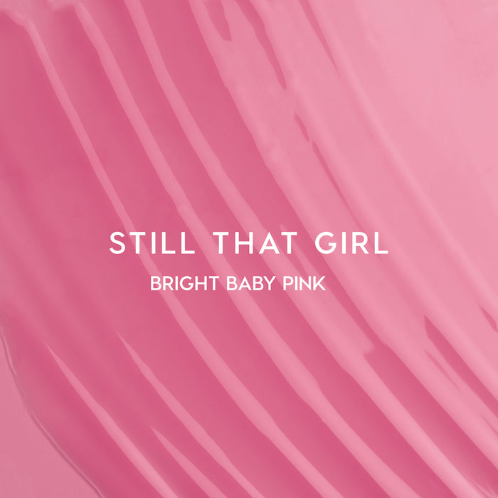 Still That Girl Ultra Glossy Lip Heart to Get swatch showing smooth, bright baby pink lip gloss spread in soft ridges across a solid pink background, highlighting its high-shine, creamy texture for bold, glossy lips.