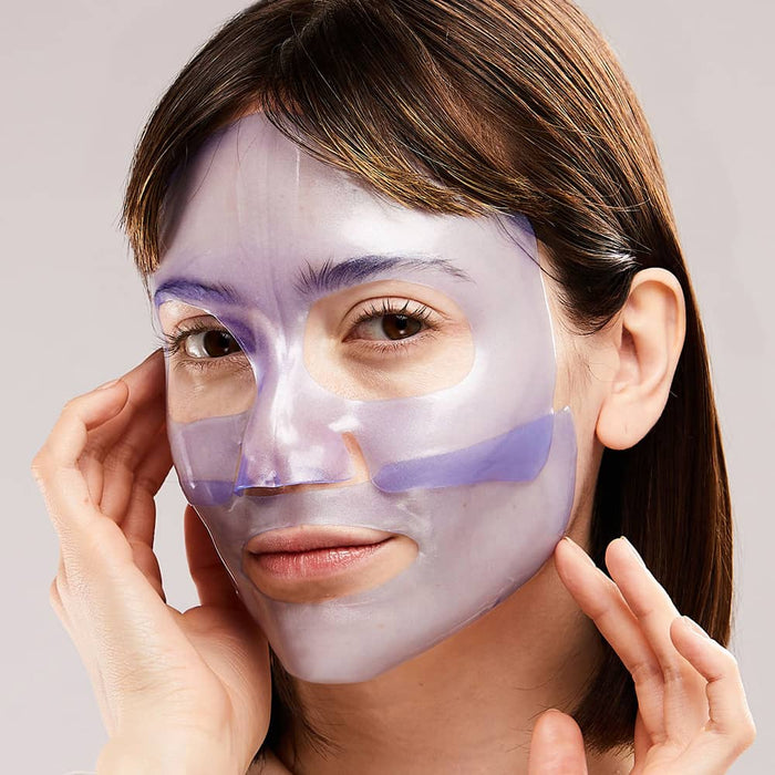 Woman wearing glossy purple hydrogel sheet mask adjusting edges during skincare treatment
