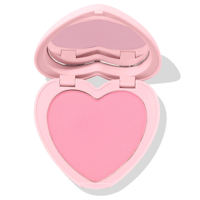 Heart-shaped Sweetheart pressed powder blush sits half open, revealing a soft matte baby-pink pan and built-in mirror in a pastel pink compact; ColourPop Pressed Powder Blush product shot on a clean white background.