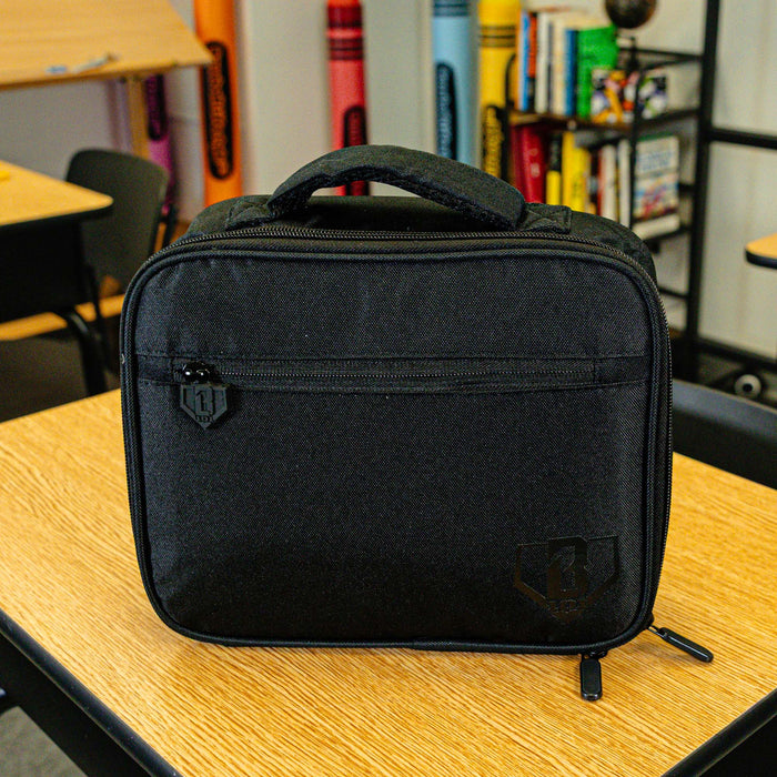Adult model wearing black lunch box with "SZN 2" design