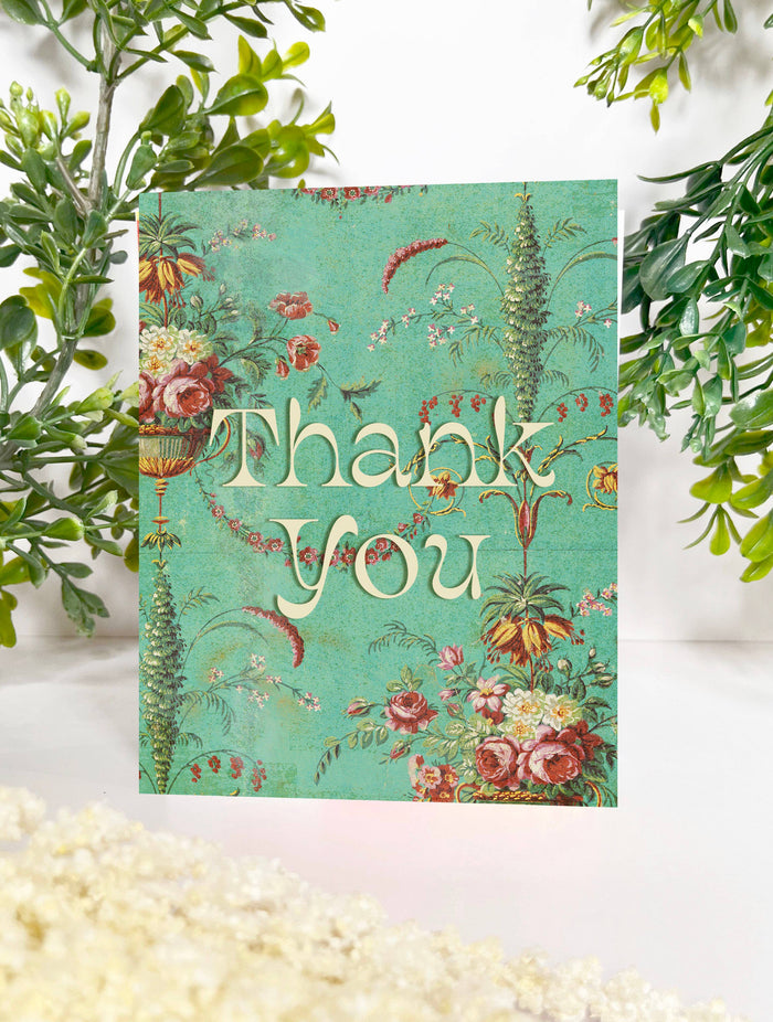Mint green floral thank you card from The Coin Laundry featuring elegant flower illustrations and a heartfelt message.