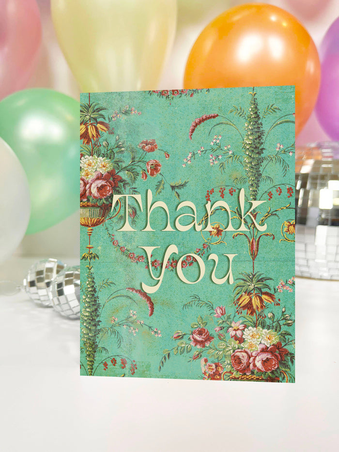 Mint green floral thank you card from The Coin Laundry featuring delicate flower illustrations on the front.