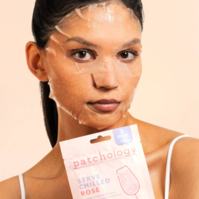 Woman with a face mask holding a 'patchology' rose hydrating cooling skincare against a beige background