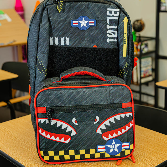Adult model wearing multi-color lunch box with "Unit 101 SZN 2" design